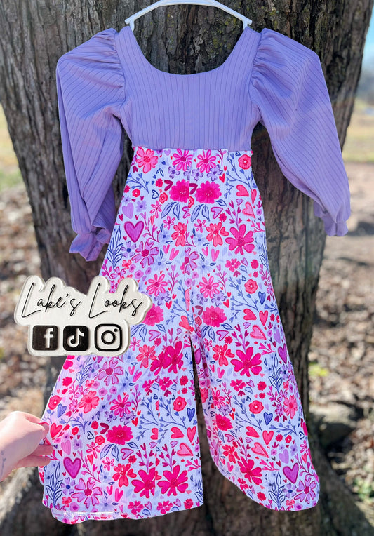 Purple top and floral dress hanging on a tree branch with 'Lake's Looks' branding.